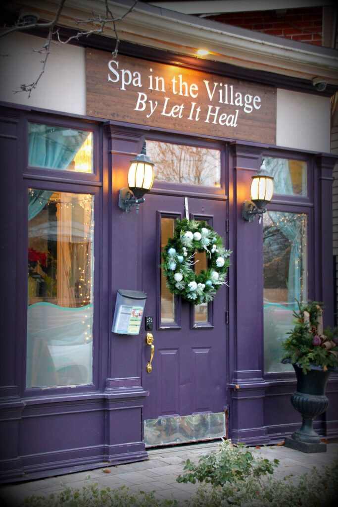 A purple door with a wreath on the front of it.