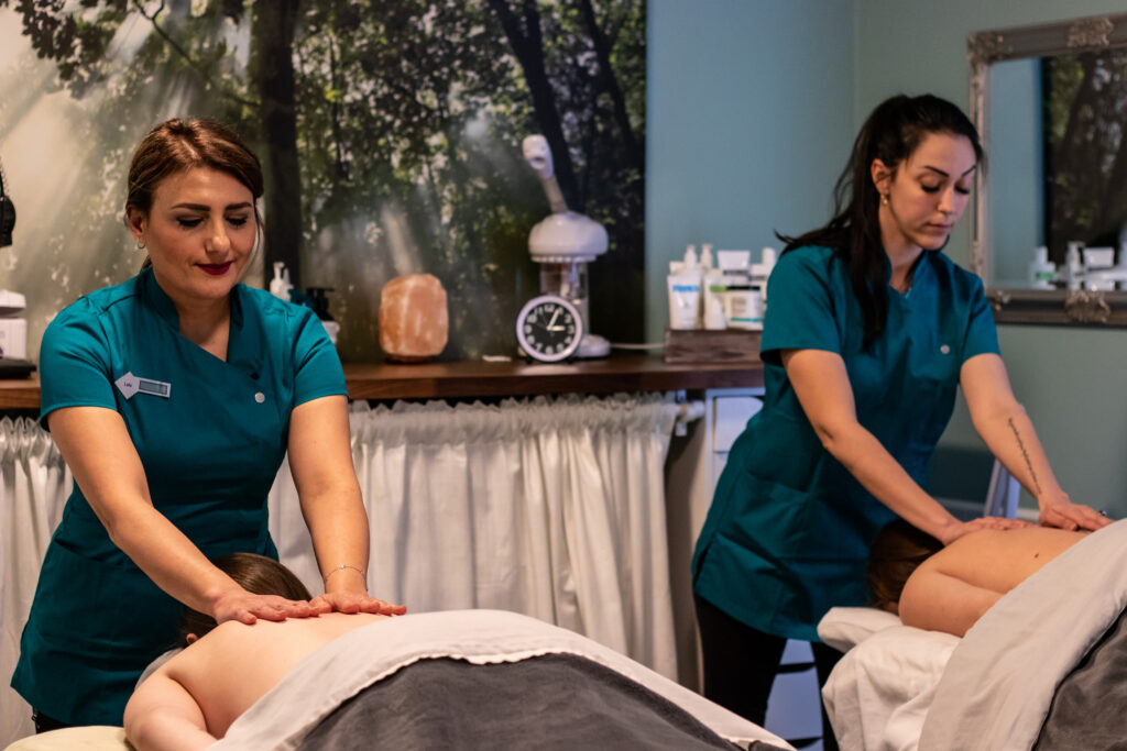 Two women are getting a massage in the spa.