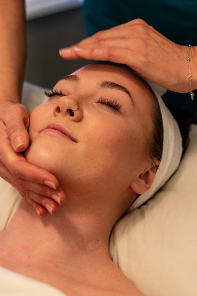 A woman getting her face waxed at the spa