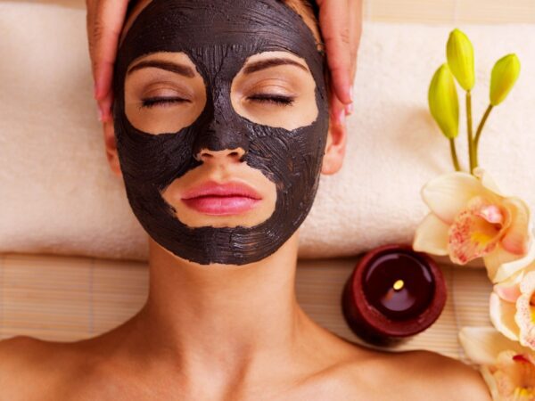A woman with black face mask on her head.