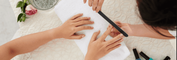 A person is getting their nails done